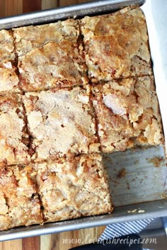 banana bread snack cake cut into squares in a pan on top of a wooden table