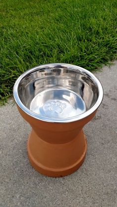 a metal bowl with a paw print on it