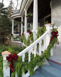 christmas garland on the front steps of a house