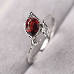 ◆ The ring is handcrafted from sterling silver and decorated with a dazzling 5*7 mm garnet and CZs. It is suitable for engagement/anniversary/daily occasion. ◆ Production Description: Main stone Type: Natural Garnet Main Stone Shape: Pear Cut Main Stone Size: 5*7 mm(1.02ct) Side stone: CZ Metal: 925 Sterling silver - Other options available in the drop down menu ◆ Customization: √Free for Add Engraving √Other Metal Type Available √Other Gemstones & Shapes Available √Personalization Requests Garnet Solitaire Birthstone Ring For Anniversary, Garnet Birthstone Ring In White Gold For Promise, Garnet Gemstone Birthstone Ring For Anniversary, Anniversary Ruby Ring With Gemstone Accents, Anniversary Ruby Birthstone Ring With Gemstone Accents, Silver Ruby Ring With Gemstone Accents For Promise, White Gold Garnet Birthstone Promise Ring, Elegant Garnet Birthstone Ring With Center Stone, Elegant Garnet Rings For Anniversary