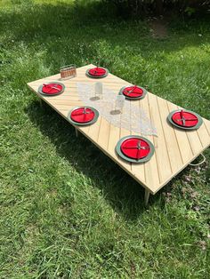 a picnic table made out of wooden boards and plates