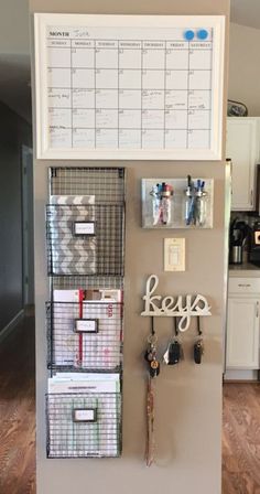 a refrigerator with several baskets and magnets attached to the wall in front of it