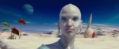 a woman with white hair and blue eyes is standing in front of an alien landscape