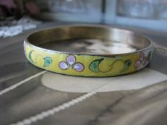 "A vintage Chinese yellow and white cloisonne bangle bracelet depicting beautiful flowers and foliage. It measures 3/8'' wide and 2 5/8'' across from side to side. Measures 8'' along the inside, so it will fit over any average hand. Stamped \"MADE IN REP. CHINA\" on the inside of the bangle. In very good condition." Handmade Vintage Bracelets For Spring, Vintage Flower Bracelets For Spring, Vintage Bracelet Jewelry For Spring, Vintage Spring Bracelet Jewelry, Vintage Spring Jewelry Bracelet, Hippie Goth, Asian Jewelry, Punk Vintage, Ear Piercing