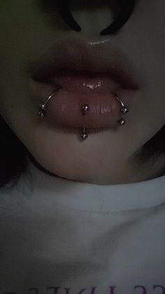 a woman with piercings on her nose