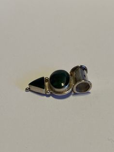 "This is a gorgeous, vintage, handmade Navajo green jade and 950 sterling silver geometric pendant. The piece measures about 1 1/4\" by 3/4\" by 3/16\". The bale opening is about 3/8\". The stones are set in polished sterling silver bezels and are vibrant. The oval-cut stone measures about 5/8\" by 3/8\" while the triangular-cut stone measures about 3/8\" by 3/8\". The piece weighs about 3.6 grams and is stamped 950. The 950 sterling silver is 95% silver compared to 925 sterling silver which is Unique Green Engraved Jewelry, Artisan Silver Jade Jewelry, Bohemian Hallmarked Green Jewelry, Green Nickel-free Collectible Jewelry, Bohemian Green Hallmarked Jewelry, Native American Vintage, Geometric Pendant, Boho Gifts, Christmas Birthday Gifts