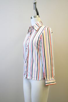 "Description: 1980s white blouse with red, blue, and black stripes. Polyester. Button front with long sleeves. Condition: In great condition, with no holes or stains. Designer: You-nique Stated Size: 7 Measurements: Armpit to armpit: 18\" Shoulder to shoulder: 15\" Sleeve length: 22.75\" Overall length: 25.5\" Waist: up to 31\" ---> If you need an order shipped by a particular date or shipped via a quicker method, please ask PRIOR to purchase to see if we can accommodate that request. Visit t White Blouse, Striped Blouse, Black Stripes, Overalls, Blouses For Women, Stripes, Sleeve Length, Long Sleeve, Red