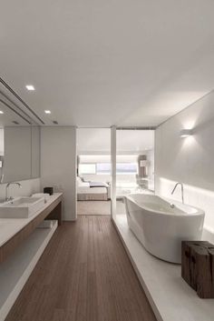 a large bathroom with two sinks and a bathtub in the middle of the room