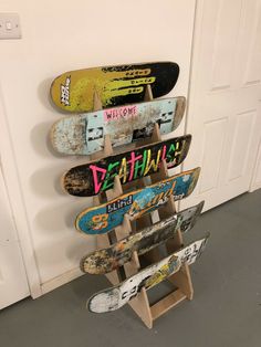 several skateboards are stacked on top of each other in a room with white doors