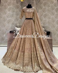 Made to Order/Measurement/Custom Order Lehenga - Color : beige gold - Fabric : Embroidered  tishu silk - Fully flared paneled lehenga - Embroidered  Blouse -  Net Dupatta with Gold Border - Drawstring closure with Tassels - - It can be customize in any design or size  PLEASE NOTE: BUYERS ARE RESPONSIBLE FOR ANY CUSTOMS AND IMPORT TAXES THAT MAY APPLY. This is a made to order product. If you opt for 'Made To Measurement Option', we will provide a measurement template and you can share the measurements likewise. If you want to opt for 'Standard Size', Please refer to the size chart provided in the listing. Shipping: Standard Shipping is done by DHL ecommerce and it mostly takes 2 to 3 weeks to deliver after dispatch. Express Shipping is done by DHL express and it mostly delivers within a wee Gold Tussar Silk Saree For Reception, Fitted Cream Sharara With Traditional Drape, Beige Silk Sharara For Wedding, Gold Tussar Silk Sharara For Designer Wear, Wedding Beige Silk Sharara, Cream Fitted Sharara With Traditional Drape, Fitted Cream Sharara For Designer Wear, Cream Fitted Sharara For Designer Wear, Festive Floor-length Beige Lehenga