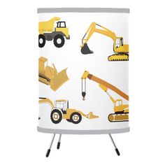 a white lamp shade with yellow construction vehicles on the front and back of it,