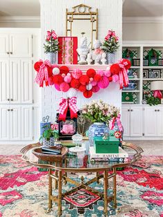 a living room decorated for christmas with pink and red decorations