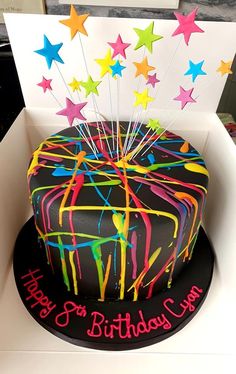 a birthday cake in a box with stars on top