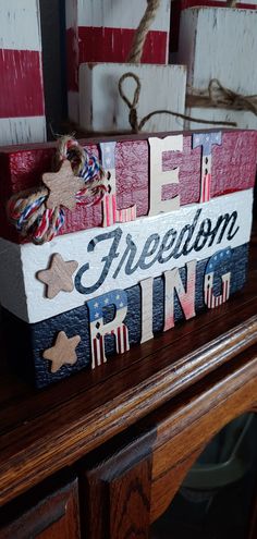 a patriotic wooden box with the word freedom painted on it sitting on top of a table