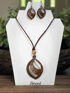 "These elegant earrings and necklaces are hand-carved from coconut shell and made in Sri Lanka, a well-known island for quality coconut shell products. The color of a coconut shell ranges from dark brown to light brown with some areas of pale creamy shades that result in beautiful unique colors and variations in the final earrings/ pendants (colors may slightly vary from the pictures).  The final product is smoothed and heavily polished. Earrings are hung from a silver hoop and pendants are hung from a cord to give the perfect look you want!! Cord length - 17\" Variations & Sizes: - Almond (Pendant H - 2.5\", W - 2\", Earrings  H - 1.2\", W - 1\") - Spotify (Pendant D - 2\", Earrings  D - 1.2\") - Light on Dark (Pendant D - 2\", Earrings  D - 1\") - Dark on Light (Pendant D - 2\", Earrings Seashell Jewelry Diy, Coconut Jewelry, Coconut Shell Crafts, Tropical Jewelry, Wood Jewelery, Nature Necklace, Seashell Jewelry, Coconut Shell, Polymer Clay Pendant