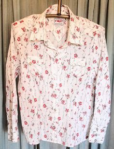 White Roper Cowgirl shirt adorned with red flowers, sequins and black stems.  The front closures and cuffs are sliver snaps.  Black trim around pockets and upaper bodice. Size is XL and in excellent condition.   Armpit to armpit is 22 inches Cowgirl Shirts, Western Shirt, Western Shirts, Black Trim, Red Flowers, Womens Clothing Tops, Favorite Outfit, Bodice, Blouses For Women