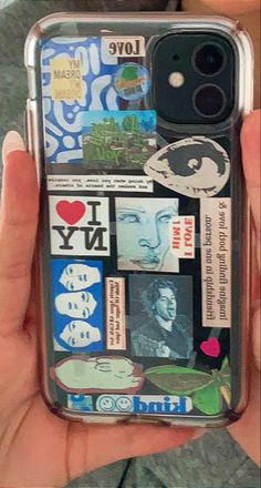 someone is holding up their phone case with stickers on it and the back cover