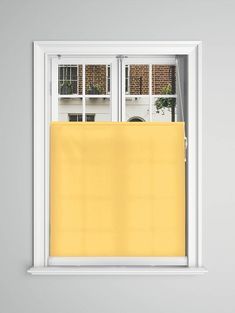 an open window with a yellow blind in it's center and two windows on the other side