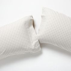 two white pillows sitting on top of each other