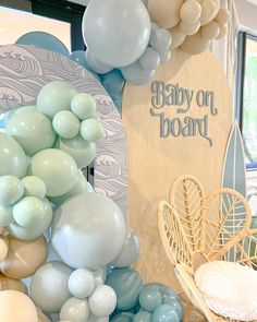 there are many balloons in the room and one is blue, white and grey with words on it