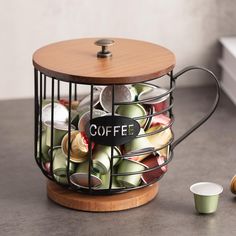 a coffee cup holder filled with cups and saucers next to a wooden lid on a counter