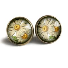 A Victorian botanical illustration of a daisy rests under a 5/8" glass cabochon.  This pretty floral earring features our signature sleek nickel free brass findings and wires. . Classic Flower Earrings Gift, Classic Flower Shaped Earrings For Gift, Nature-inspired Nickel-free Round Flower Earrings, Nickel-free Daisy Earrings For Gifts, Nickel-free Botanical Flower Earrings, Nickel-free Daisy Flower Earrings Gift, Nickel-free Round Brass Flower Earrings, Adjustable Birth Flower Earrings, Victorian Botanical