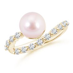 a pearl and diamond ring on a white background