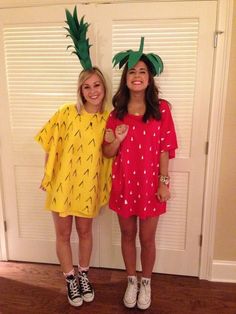 two girls dressed up as pineapples standing next to each other in front of a door