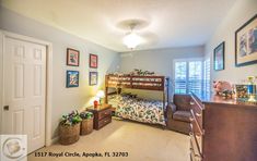 a bedroom with a bunk bed next to a dresser