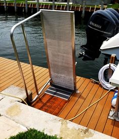 a boat docked next to a dock with water hoses