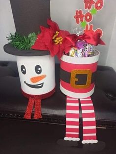 two cups with candy in them are decorated to look like santa claus and snowman