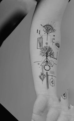 a woman's arm with a tree and geometric shapes on it, in black and white