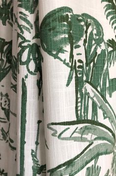 a green and white curtain with an image of a man in the woods on it