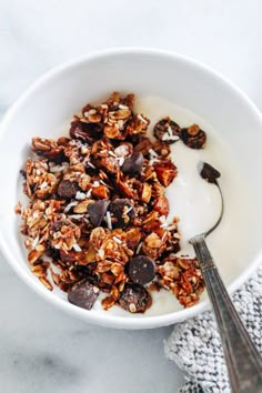 a bowl filled with granola and chocolate chips