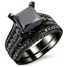 a black diamond ring set on top of each other with two rows of diamonds around the band