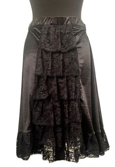 "This is a Victorian style gothic steampunk skirt with an elasticated waistband . This is a black midi length velvet mix skirt .can be worn with a corset . It has black lace trim  to the boarder. It also has ruffles of lace towards the back, tiered please see photos. It's a free size ,waist 25 before stretch . Stretches to approx 38\".please refer to photo for length . This is a midi  Available in 3 colour ways:- Black Red Purple Thank you for looking" Black Gothic Velvet Bottoms, Black Velvet Gothic Bottoms, Gothic Tiered Ruffle Skirt, Steampunk Black Ruffled Skirt, Gothic Tiered Skirt For Costume, Steampunk Black Skirt With Ruffles, Steampunk Ruffled Skirt For Halloween, Black Steampunk Skirt With Ruffles, Steampunk Ruffle Skirt For Halloween