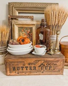 an old wooden box filled with lots of different items and some pumpkins on top