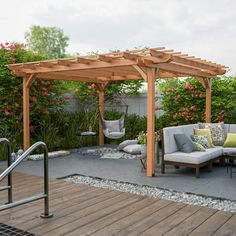 an outdoor living area with couches, chairs and a wooden pergoline structure