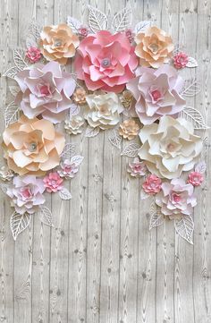 paper flowers are arranged on a wooden surface