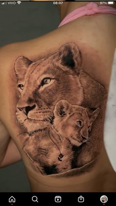 a woman with a tattoo on her stomach shows the image of two lions and their cubs