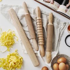 an assortment of kitchen utensils and ingredients laid out on a table