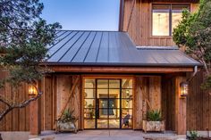 the front entrance to a home with wooden siding