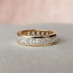 a wedding band with three princess cut diamonds