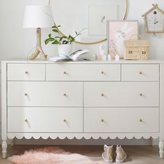 a white dresser topped with lots of drawers