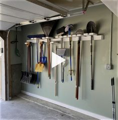 a garage filled with lots of tools hanging on the wall