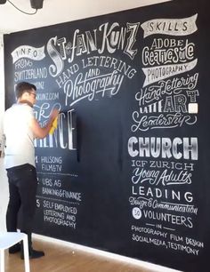 a man standing in front of a blackboard with writing on it