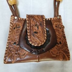 "Great bag, great condition! Never used, new! 8.5\" wide x 6.5\" high x 2\" leather hand tooled Zaria label on front Wooden beads" Vintage Brown Hand Tooled Rectangular Shoulder Bag, Vintage Brown Rectangular Hand Tooled Shoulder Bag, Brown Hand-tooled Crossbody Shoulder Bag, Brown Hand Tooled Crossbody Shoulder Bag, Hand Tooled Leather Satchel For Festival, Artisan Hand-tooled Shoulder Bag For Festivals, Bohemian Hand Tooled Leather Shoulder Bag, Brown Bohemian Shoulder Bag With Leather Backing, Bohemian Brown Shoulder Bag With Leather Backing