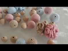 several crocheted beads are arranged on a table