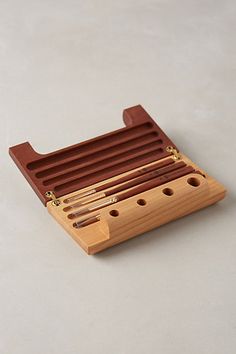 a wooden musical instrument holder with four pieces of wood in the middle and two strings attached to it