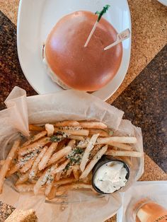 a burger and french fries on a table